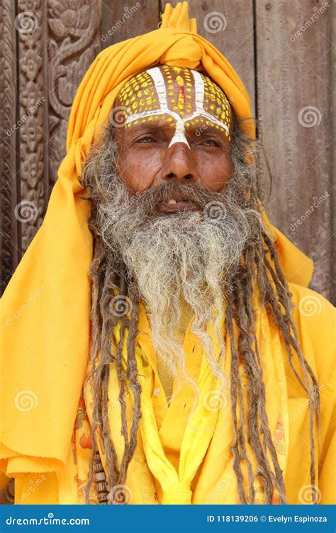 sadhu baba holy man plays  pipe  pashupatinath temple nepal