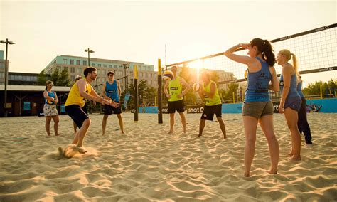 Download Men And Women Playing Beach Volleyball Wallpaper | Wallpapers.com