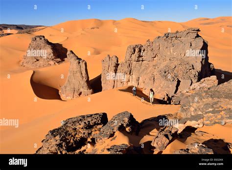 people hiking   sand dunes  rocks  moul naga tadrart