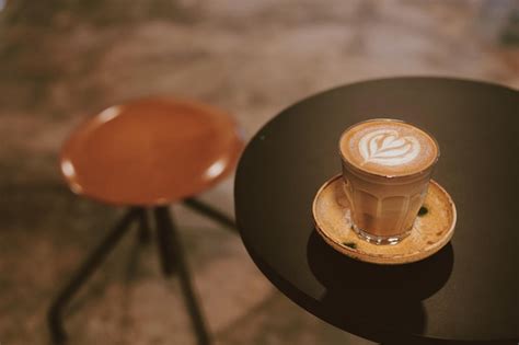 Premium Photo | A glass of coffee latte art on table.