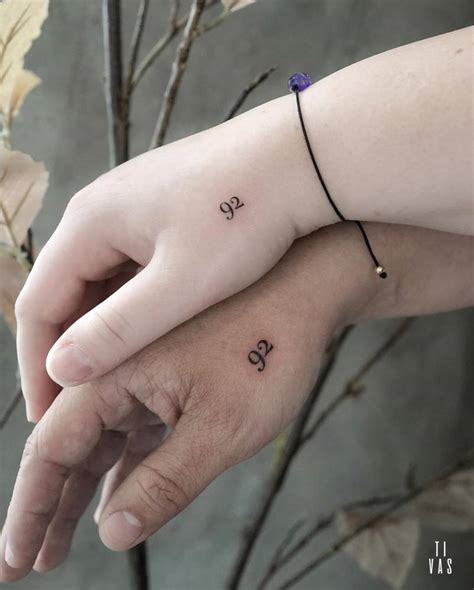 Matching number "92" tattoo for couple.