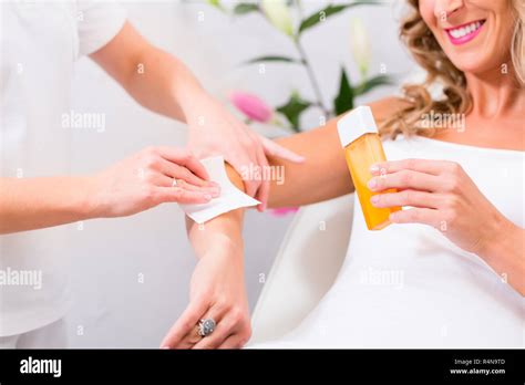 Woman at waxing hair removal in beauty parlor Stock Photo - Alamy