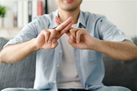 Happy young deaf man using sign Language to communicate with other