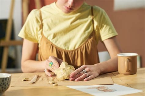 Premium Photo | Closeup of young creative craftswoman making human face ...