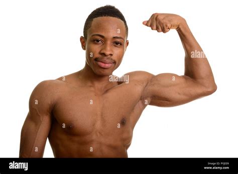 Portrait of young African man flexing bicep muscle Stock Photo - Alamy