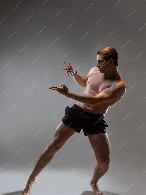 Premium Photo | Young muscular man in an expressive pose artistic pose