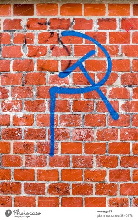 Hammer and sickle graffiti on white wall - a Royalty Free Stock Photo from Photocase