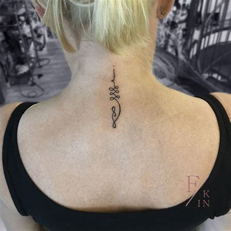Unalome tattoo on the back of the neck.