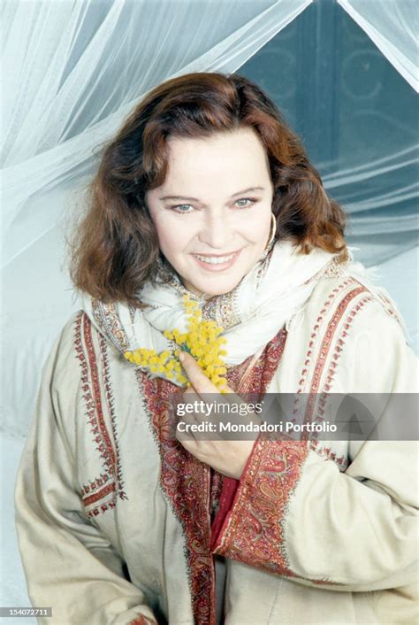 Portrait of Italian actress Laura Antonelli holding a bunch of... News