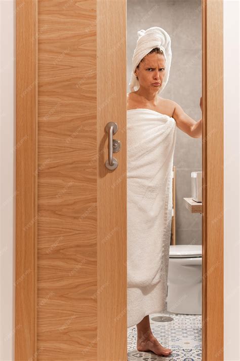 Premium Photo | Woman annoyed at being spied on closes bathroom door