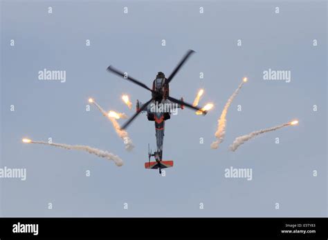 AH-64 Apache attack helicopter in a looping firing off flares Stock ...