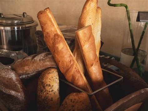 Premium Photo | Assortment of baked breads french baguette on wood box