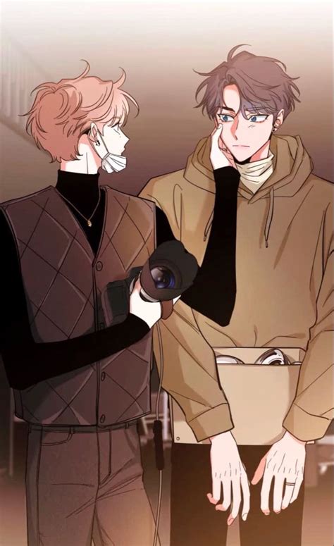 two people standing next to each other with one holding a camera