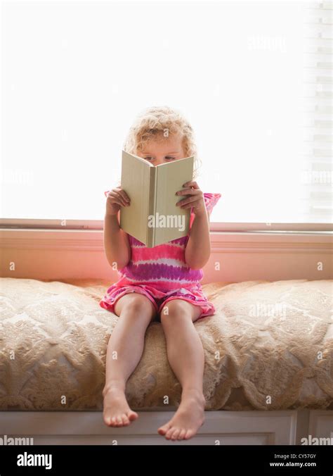 USA, California, Los Angeles, Girl sitting and reading book Stock Photo ...