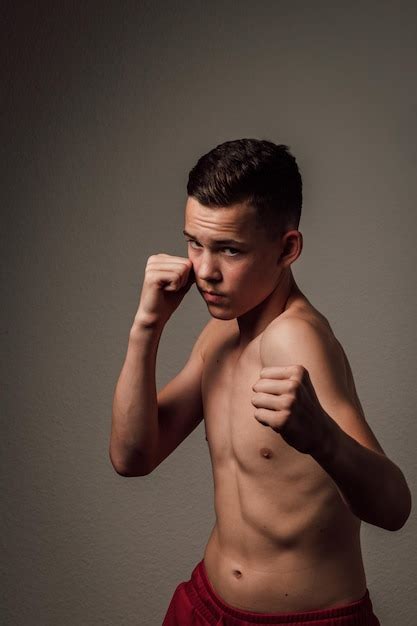Premium Photo | A teenage boxer athlete is training to box on dark ...