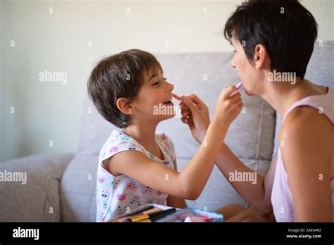 Mother and her little daughter doing make up for each other Stock Photo ...