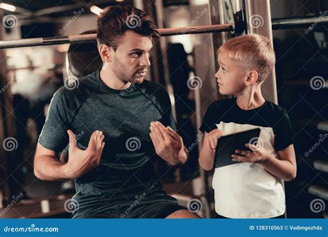 Father and Son in Gym. Information on Tablet Stock Image - Image of ...