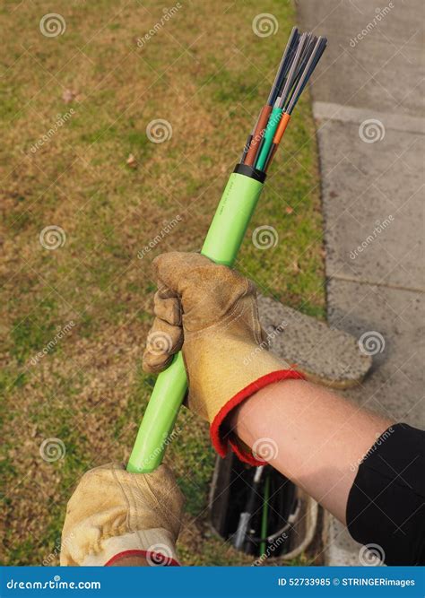 Green Fiber Optic NBN Cable Behind An Installation Truck Editorial