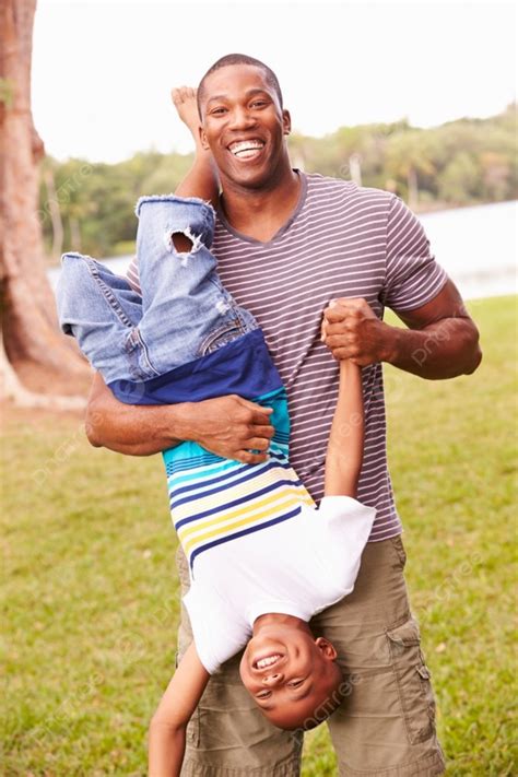 Father And Son Having Fun In Garden Together Background And Picture For
