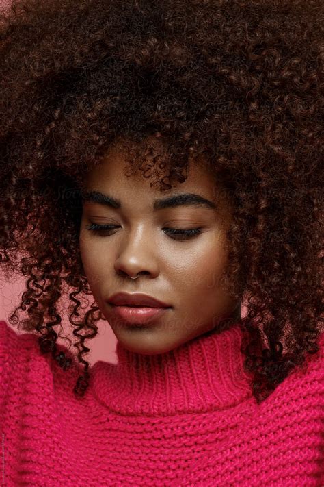 "Portrait Of A Young African American Afro Woman In Pink Studio Looking