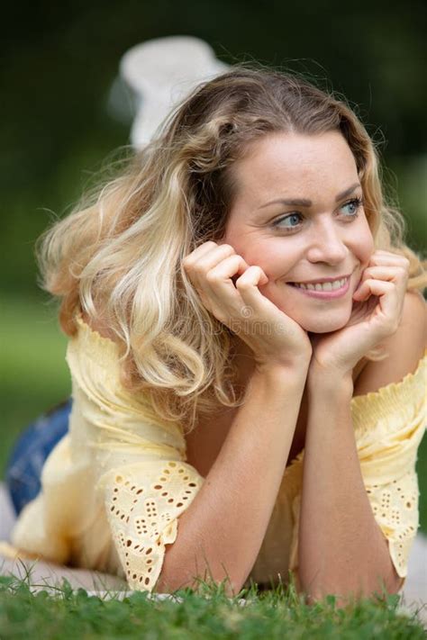 Beautiful Young Woman Outdoors Enjoy Nature in Green Grass Stock Photo