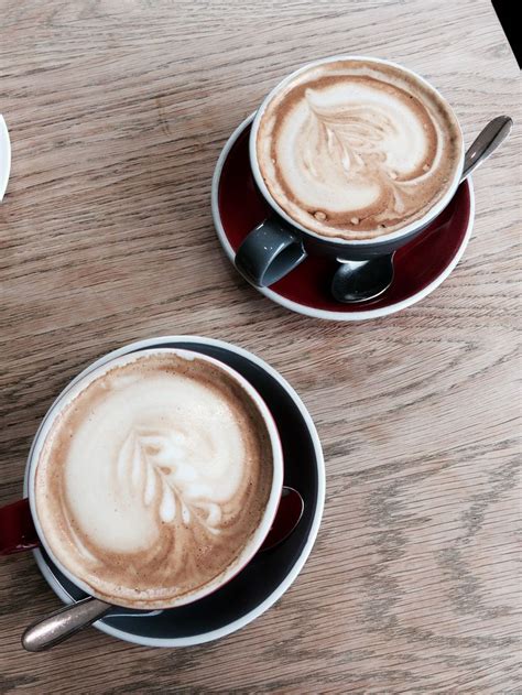 Two Cups of Cappuccino on a Wooden Table