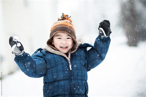 "Asian Boy Playing Snow Outdoor In Winter" by Stocksy Contributor "Take A Pix Media" - Stocksy