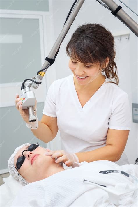 Premium Photo | Medical salon woman employee uses effective neodymium