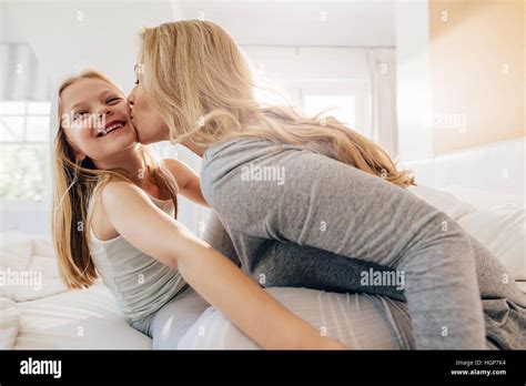 mother kiss daughter  res stock photography  images alamy
