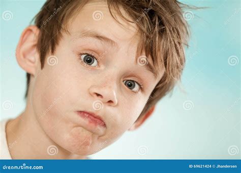 exasperated young boy blowing   cheeks stock photo image