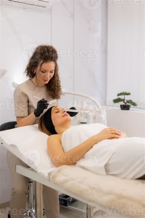 Revitalizing skin treatment with serum retinol by a skilled