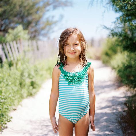 "Cute Young Girl Standing By A Beach Walkway In A Bathing Suit" by Stocksy Contributor "Jakob ...