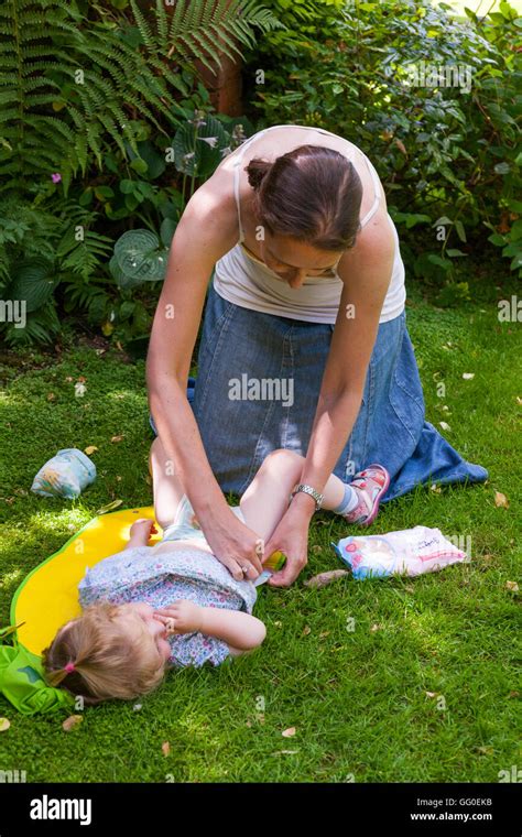 Mum mother parent carer changing nappies nappy change of baby toddler ...