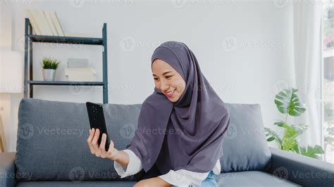 Asia muslim lady wear hijab using phone video call talking with couple