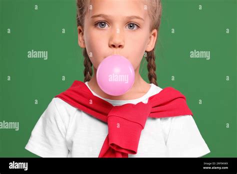 girl blowing bubble gum  green background stock photo alamy