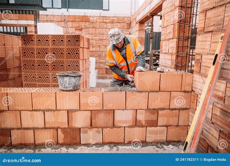 industrial worker bricklayer mason working  bricks stock image