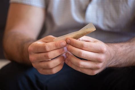 hands   man rolling  cigarette  stock photo
