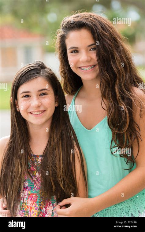 Mixed race sisters smiling outdoors Stock Photo - Alamy