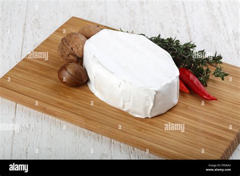 Brie cheese with thyme leaves and nuts Stock Photo - Alamy