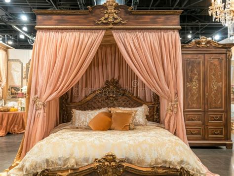 ornate canopy bed  peach drapes  golden details   luxurious