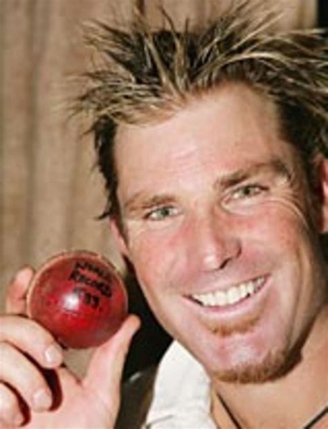A grinning Shane Warne celebrates breaking the world record