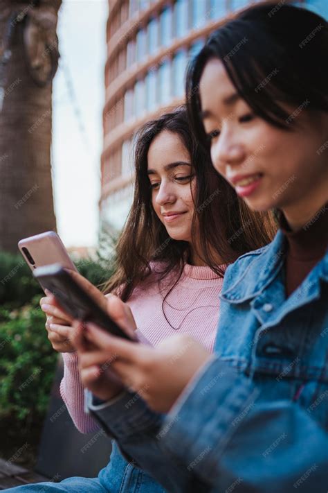 Premium Photo | Two friends sending text messages to friends on their