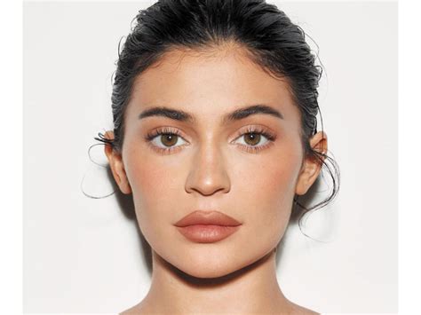 Kylie Jenner flaunts her gorgeous figure in a skintight nude dress as