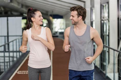 Premium Photo | Happy friends running together on track