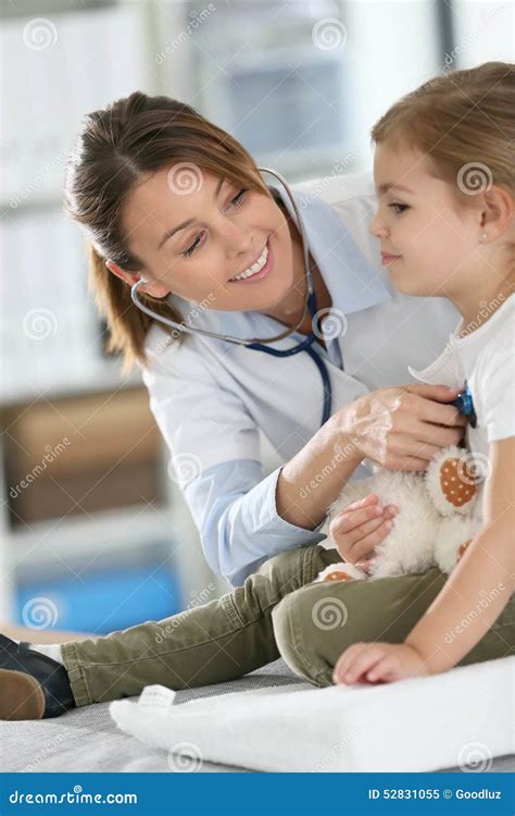 Young Pediatrician Doctor Examining Little Girl with Stethoscope Stock ...