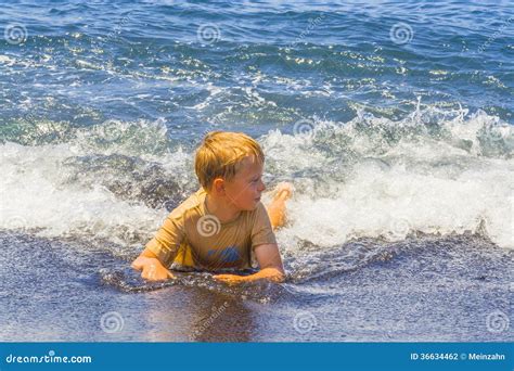 boy  fun playing   waves stock photo image  ocean emotion