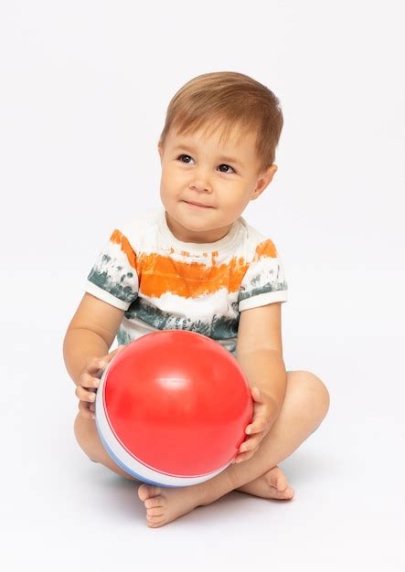 Premium Photo | A cute image of a baby holding a ball