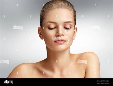 Attractive woman with perfect skin on grey background. Skin care ...