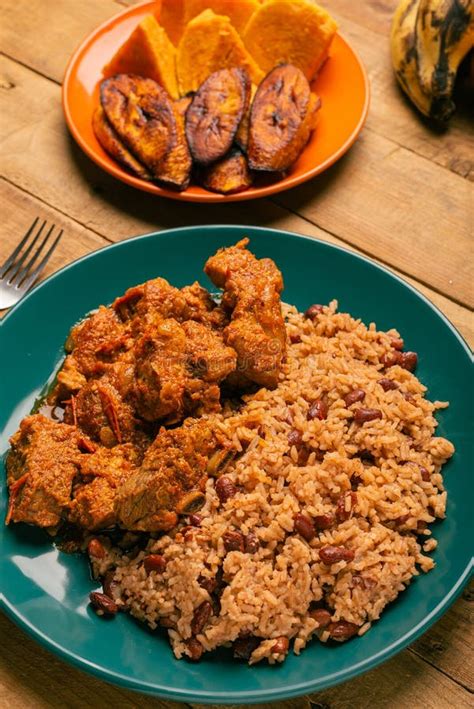 rice congri  pork fricassee  fried ripe plantain stock photo