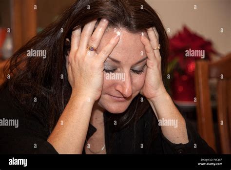 Exasperated woman age 44 holding her head with her hands. Mahtomedi ...